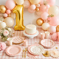 First birthday party kit styled table setup with gold number 1 balloon