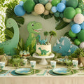 Dinosaur party kit styled table with balloon arch and cake